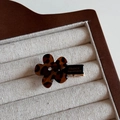 Detailed close-up of leopard pattern flower hair clip with silver rhinestone in wood box - Dark Flower / Duckbill Hair Clips