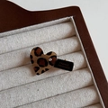 Detail of handmade leopard heart hair clip with crystal on a linen jewelry tray - Light Heart / Duckbill Hair Clips