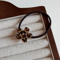 Detail of leopard print flower hair tie with a sparkling crystal center in a display box - Light Flower / Hair Tie