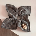 Detailed close-up of a plaid hair scrunchie with a cute small knitted bear doll accent - Gray Plaid - Fabric Ring