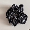 Detail of black striped scrunchie featuring a satin texture and elegant pearl pendant - Classic Scrunchie / Black Striped Scrunchie