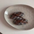 Detail shot of two plaid fabric hair clips with brown bows on a ceramic plate - Gray Plaid - Hair Clip Pair