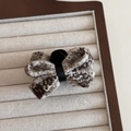 Close-up of the vintage tweed fabric texture and black velvet center on the bow hair clip - Beige Bow Claw Clip