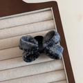 Close-up of elegant blue tweed bow hair clip with satin center on a velvet tray - Fog Blue Bow Claw Clip
