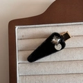 Detail of a black velvet triangle hair clip with a square gray gemstone and silver tag - Square Rhinestone Velvet Black Triangle / Black
