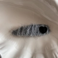 Macro detail of fuzzy grey heart hair clip on a white ceramic plate with wavy texture - Black Heart Teardrop Yarn Wrapped