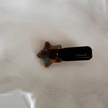 Detailed view of handmade star-shaped acetate hair clip with gold France engraving - Blue Brown Acetate-Star
