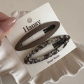 Detail of floral and solid brown fabric BB hair clips set on a white display card - Coffee Floral BB - Hollow Oval