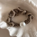 Close-up of brown ruffled hair scrunchie with white plush edges and a large pearl bead - Light Coffee
