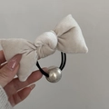 Detail of cream velvet bow hair tie with polished silver bead and elastic band - Bow Scrunchie / Beige