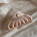 Close-up of pink marble pattern claw clip with unique moon-shaped cutout design - Crescent Jellyfish Style / Wavy Toffee
