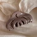 Macro detail of wave patterned mauve hair claw clip on soft beige textured linen fabric - Cocoa Milk Ripple - Jellyfish Crescent