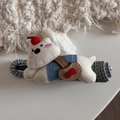 Macro detail of cute white knitted bear hair claw clip with blue fabric texture base - Funny White Puppy - Hair Bun Duckbill Clip