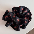 Close-up of black floral scrunchie with red roses and white polka dots pattern - Black Rose