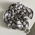 Detail of grey striped scrunchie showing fabric texture and woven brand label - Simple Blue Stripe Scrunchie