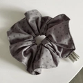 Detailed macro view of grey fabric scrunchie with polka dots and soft pleated texture - Gray Dots Scrunchie