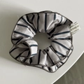 Close-up of gray striped fabric hair tie with blue vertical lines and branded tag - Simple Blue Stripe Double Layer