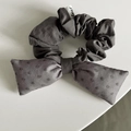 Detail of dark grey hair scrunchie with bow tie and tiny dear tag on white background - Gray Dots Bow