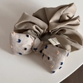 Detail eines handgefertigten Khaki-Haargummis mit beigen Punkten und Etikett - Beige Schleife Haargummi mit 3D-Punkten