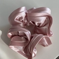 Detalle del coletero de satén rosa que muestra la delicada tela perlada y la textura plisada - Rosa