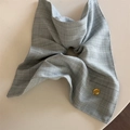 Close-up of grey plaid scrunchie with a gold metal tag engraved Believe In Yourself - Pale Green Square Scarf