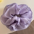 Detailed texture of lavender purple ruffled scrunchie with delicate wavy stitched edges - Purple