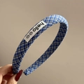 Close-up of blue plaid headband with hello label and smiley icons on fabric - Hello Blue Plaid Style (FQ881417)