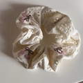 Detail of white cotton scrunchie with hollow floral embroidery and cherry patterns - Creamy White Cherry Scrunchie