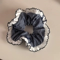 Detailed shot of blue gingham scrunchie with white ruffle edges and small bow accents - Fine Plaid Petal Style (FQ881417)
