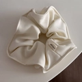 Detailed macro view of cream-white twill fabric scrunchie with Hand Made woven label - Candy Series Hair Tie - Cream White