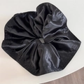 Close-up of black satin scrunchie with high-density pleats and premium glossy texture - Pleated Satin Scrunchie-Black