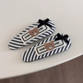 Detail of two black and white striped hair clips with cute flocked bear and ribbon bow - Black Striped Hair Clips with Bear Label