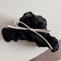 Détail d'un chouchou en tulle noir avec un nœud contrastant en similicuir blanc élégant - Noir