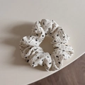 Detailed close-up of a floral scrunchie featuring black patterns on textured white fabric - Small / Off-White Black Floral