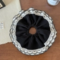 Detailed close-up of a large black pleated scrunchie with delicate white lace edges - Black
