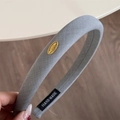 Padded light gray fabric headband for women with golden metal brand logo tag - 2 cm / Blue