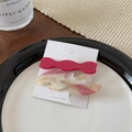 Detail of a magenta wavy clip and marble acetate hairpin on white display card - Peach Pink