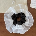 Primer plano de un coletero a rayas negras con volantes dobles de malla blanca suave - Negro