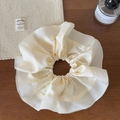 Close-up of cream ruffled satin scrunchie with layered lace detail on dark wood surface - Rice White Contrast Scrunchie