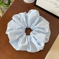 Detail of light blue floral scrunchie with white butterfly print on wood surface - Light Blue