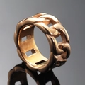 Minimalist rose gold Cuban link ring with a polished finish on a black reflective surface - US 7 / Rose Gold