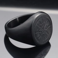Macro shot of matte black stainless steel ring featuring a compass star engraving and text - Size 7 / Black