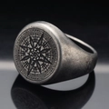 Macro detail of punk septagram compass ring with vintage silver finish and engraved letters - Retro Colors