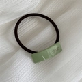 Detail of green acrylic hair tie with FRANCE Handmade engraving on elastic rubber band - Hair Tie / Green