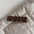 Macro shot of a rectangular leopard print hair clip on a quilted fabric background - Leopard Print Rectangle Clip