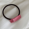 Detail of pink resin decoration on black elastic hair tie with France Handmade text - Hair Tie / Rose Red