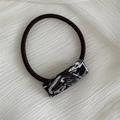 Macro detail of France Handmade marble texture hair tie with elastic band on fabric - Hair Tie / Black and White
