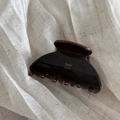 Close-up of a dark brown jelly-textured hair claw clip with golden baby vovo lettering - Chocolate Brown