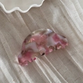 Detail view of pink and white marble acetate hair claw with elegant gold label - Gold Label Jelly Pink