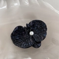Detail of a butterfly orchid hair clip featuring purple acetate texture and center pearl - Dark Purple